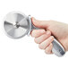 A hand holding a silver pizza cutter.