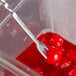 A Tablecraft bar mixing spoon with a fork on a round red object.