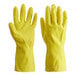 A hand wearing a yellow Cordova latex rubber glove.