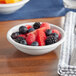 A bowl of fruit in a white Acopa stoneware bowl.