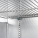 A metal shelf inside a Beverage-Air black back bar refrigerator.