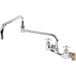 A chrome T&S wall mount faucet with two handles and a hose.