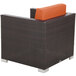 A BFM Seating Aruba wicker armchair with rust canvas cushions.