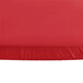 A Creative Converting Stay Put Real Red round plastic tablecloth with elastic on a table.