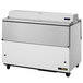 A True milk cooler with white and stainless steel exterior and wheels.