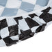 A white rectangular tablecloth with a black and white checkered pattern and elastic edges.