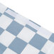 A close-up of a blue and white checkered plastic tablecloth with elastic edges.