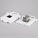 A white rectangular object with metal parts inside.