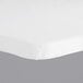 A white rectangular plastic tablecloth with elastic on a white table