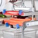 A person using a Prince Castle Saber King machine to cut vegetables.