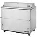 A True milk cooler with stainless steel exterior and interior on wheels.