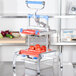 A Prince Castle Saber King Tomato Slicer with tomatoes on it.