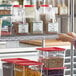 a person holding a stack of plastic containers