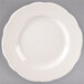 A Tuxton ivory china plate with a scalloped edge.