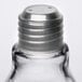 A close-up of an American Metalcraft glass light bulb salt shaker with a silver metal cap.