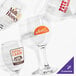 A group of Acopa customizable wine glasses with custom labels.