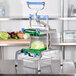 A Prince Castle Saber King lettuce chopper on a table with lettuce in it.
