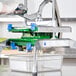 A person using a Prince Castle lettuce chopper machine to cut vegetables.