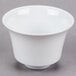 A CAC Citysquare white porcelain cup on a gray surface.