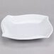 A white irregular square Elite Global Solutions melamine platter.