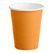 A close up of a Creative Converting pumpkin spice orange paper cup with a white rim.