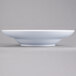 An Elite Global Solutions white melamine bowl on a gray surface.