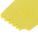 A yellow plastic Mercer Culinary lancet arch plating tool with numbers and symbols on the surface.