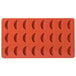 A red Martellato silicone mold with 24 tangerine slice shapes.