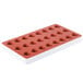 A red and white heart shaped silicone mold with 24 compartments.