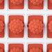 A red silicone Martellato fruit jelly mold with 24 raspberry-shaped compartments.