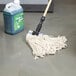 A Rubbermaid White Cotton Looped End Wet Mop Head next to a mop and bucket.