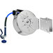 A close-up of a T&S metal hose reel with a hose attached.