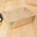 A Fold-Pak Sonoma paper take-out box with a lid.