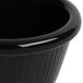 A close up of a black fluted Carlisle melamine ramekin.