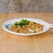 A Blue Bamboo melamine plate with rice, broccoli and chicken with chopsticks.