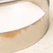 An American Metalcraft stainless steel circular dough cutting ring with a handle.