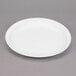 A white Libbey porcelain plate with a rim on a gray surface.