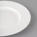 A close-up of a Libbey Royal Rideau white porcelain plate with a wide white rim.