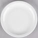 A Libbey white porcelain plate with a white rim on a gray surface.