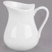 A white Libbey porcelain creamer with a handle.