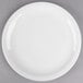A Libbey round white porcelain plate with a narrow white rim on a gray surface.