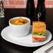 A sandwich and soup on a Libbey white porcelain racetrack plate.