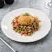 A Libbey white porcelain coupe plate with a fried meatball and rice on it.