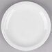 A Libbey white porcelain plate with a white rim on a gray surface.