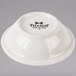 A white Tuxton China bowl with black embossed text.