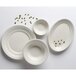 A group of Tuxton Hampshire eggshell embossed china fruit dishes with seeds on them.