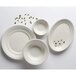 A group of Tuxton Hampshire white oval china platters with an embossed design.