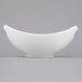 A close-up of a Libbey white porcelain bowl with handles.