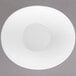 A round white porcelain bowl with a small hole in the middle.