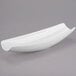 A white Libbey Royal Rideau porcelain canoe plate with a curved edge on a gray surface.